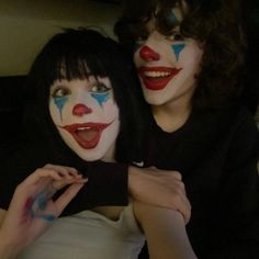 two women with clown makeup on their faces and one has her arm around the other's shoulder