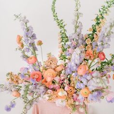 an arrangement of flowers is displayed on a chair