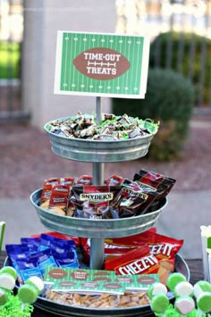 three tiered trays filled with snacks on top of a table