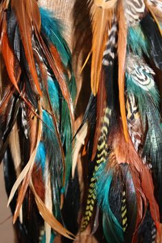 "Handmade and topped with a tuquiose colored howlite stone. They are packed with natural and dyed feathers are super light and comfortable to wear. Please choose length and style from drop down menu. A 14\" earring set is shown in the photos above. Symbolism: Blue feathers give mental abilities, peace, and protection. Also psychic awareness. White feathers symbolize purification, spirituality, hope, protection, peace, and blessings of the Moon. Brown feathers give stability and respect. They als Feather Earrings Diy, Feather Symbolism, Feather Cuffs, Feather Ear Cuff, Feather Extensions, Blue Feathers, Earrings Feather, Feather Hair Extensions, Hair Extension Clips