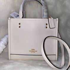 Coach Dempsey Tote 22 New With Tags 100 % Authentic Chalk And Gold Tone Hardware Approximate Measurements L 8.75" H 7.75" W 4.25" Refined Pebble Leather Handles With 4.25" Drop Long Strap With 22.5" Drop Included Smoke And Pets Free Coach Dempsey Tote 22 White, Coach Dempsey Tote 22, Coach Dempsey Tote, Branding Coach, Coach Crossbody, Accessories Bags Purses, Coach Crossbody Bag, Coach Leather, Leather Handles