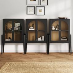 a living room scene with focus on the sideboard and shelves that have glass doors