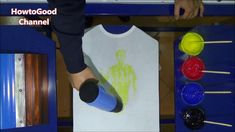 a person is painting a t - shirt on a table