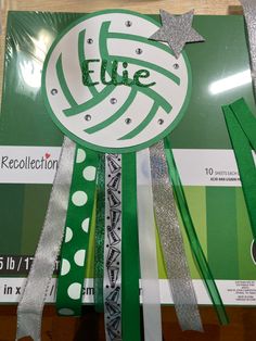 a green and white ribbon with the word file surrounded by other ribbons on a wooden table