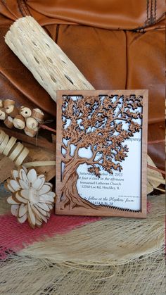 a wooden frame with a tree and flowers on it sitting next to some other items