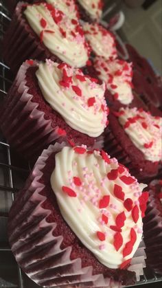 red velvet cupcakes with white frosting and sprinkles