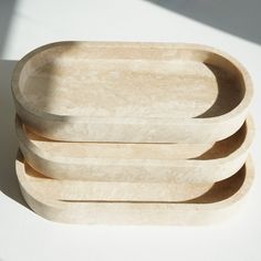 four wooden plates stacked on top of each other