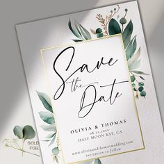 an elegant save the date card with greenery