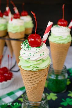 cupcakes in ice cream cones with cherries and candy canes on top