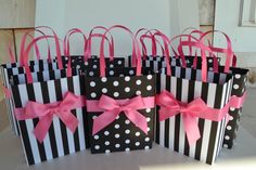 several black and white bags with pink bows