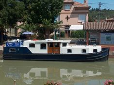 a house boat is docked in the water