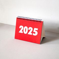 a red calendar sitting on top of a white table