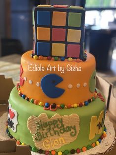 a birthday cake decorated with rubik blocks