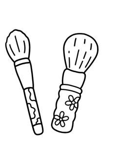 two brushes with flowers on them sitting next to each other