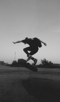 a man flying through the air while riding a skateboard