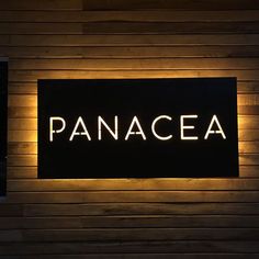 an illuminated sign that reads panacea