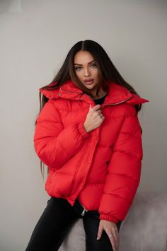 Stay warm and stylish this season with the Oversize Women's Puffer, the ultimate winter essential. Designed with a roomy, oversize cut, this puffer jacket combines both comfort and modern flair. Its high collar and voluminous hood offer extra protection from the cold, while the sleek midi jacket length ensures full coverage without compromising on movement. Crafted from waterproof fabric and filled with eco-friendly puff insulation, this women's puffer is ideal for chilly days, with a temperatur Red Puffer Jacket With Pockets, Red Long Sleeve Winter Puffer Jacket, Trendy Oversized Red Outerwear, Trendy Winter Puffer Outerwear, Red Winter Puffer Outerwear, Casual Red Winter Outerwear, Red Puffer Outerwear For Cold Weather, Red Puffer Jacket For Fall Outdoor Activities, Red Winter Outerwear For Streetwear