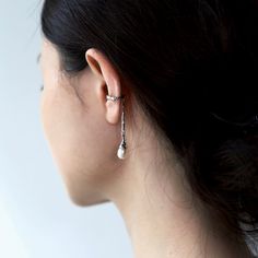 Our Fluidity collection captures the unstoppable flow of nature, from the fiery rush of lava to the graceful swell of waves. Each piece is a nod to your free spirit and bohemian heart. — Droplet is a sleek cuff that wraps around your ear like a whisper of winter, then dramatically drops down in an ice-spike design. At the end of the spike dangles a shiny white pearl, perfectly shaped like a droplet, ready to catch the light (and the attention) at every turn. The price is for one piece only. No p Adjustable Bohemian Ear Cuff, Bohemian Style Ear Cuff For Festivals, Bohemian Festival Ear Cuff, Silver Ear Cuff, Pearl Drop, White Pearl, Free Spirit, Pearl White, Ring Earrings