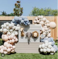 an elephant statue surrounded by balloons in front of a house