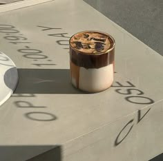 a cup of coffee sitting on top of a table