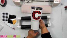 someone is making a cup with the letter c on it and other items surrounding it