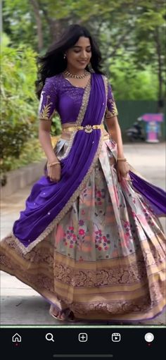 a woman in a purple and gold dress is walking down the street with her hand on her hip