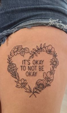 a woman's thigh with a tattoo saying it's okay to not be okay