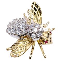 Absolutely stunning, excellent condition diamond brooch made in 18KT yelllow & white gold by Herbert Rosenthal. A rare find because this is the large version. CENTER STONE: NATURAL DIAMONDS CARAT: 1.55CT CLARITY: VS1-VS2 COLOR: F CUT: ROUND BRILLIANT OTHER GEMSTONE(S): 2 small round rubies 1.8mm GRAM WEIGHT: 9.90gr GOLD: 18KT yellow gold CLOSURE: pin MEASUREMENTS: 1.25 X 1 INCHES LONG DESIGNER: Herbert Rosenthal WHAT YOU GET AT STAMPAR JEWELERS: Stampar Jewelers, located in the heart of Jupiter, Florida, is a custom jewelry store and studio dedicated to providing 100% satisfaction to each client. Our personal attention to detail, passion, affordability and honesty set us apart from any other store. We will bring full catering of our services to you online through phone calls, consultations Diamond Yellow Gold Brooches Fine Jewelry, Yellow Gold Diamond Brooch Fine Jewelry, Yellow Gold Diamond Brooches Fine Jewelry, Yellow Gold Diamond Brooch In Fine Jewelry Style, Diamond Yellow Gold Brooch For Anniversary, Anniversary Diamond Brooch In Yellow Gold, Anniversary Yellow Gold Diamond Brooch, Jupiter Florida, Bee Pin