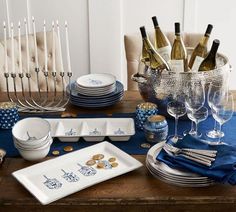 an image of a table set for a party with wine glasses, plates and utensils