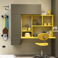 a yellow chair sitting in front of a desk with a surfboard on the wall