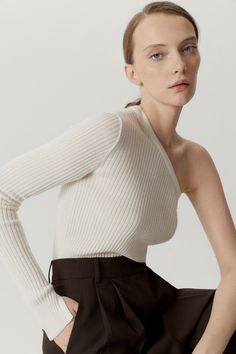 COMPOSITION: 100% Merino wool FIT: Fits true to size, take your usual size Designed for a close fit Vovk is 1.73 m (5.67 ft) tall and wears size S DESIGNER NOTES: Rib stitch Gauge 14, 1ply Slit cuff One-shoulder cut MATERIAL: 100% Extrafine merino wool Extrafine Merino Wool Merino wool is a natural fiber grown by Merino sheeps. It’s thinner than regular wool making it softer and more comfortable on your skin. When you wear it next to skin, a lot of benefits come with it. Merino wool is breathabl Essential Clothing Pieces, Rib Stitch, Cold Night, Shoulder Cut, Beautiful Knitting, One Shoulder Tops, Knitwear Women, Vneck Sweater, Merino Wool