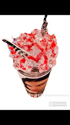 a cup filled with ice and candy on top of a table