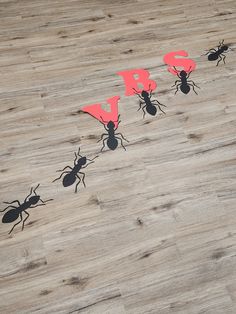 the ants are standing on top of each other and have red letters that spell out their names