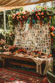 a table with pictures and flowers on it in the middle of a room filled with plants