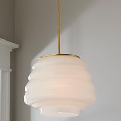 a white light hanging from a ceiling in a room