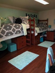 a bedroom with two bunk beds and blue rugs on the wooden floor next to each other