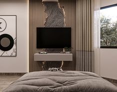 a bedroom with a bed, tv and art on the wall