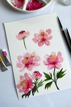 watercolors are being used to paint pink flowers