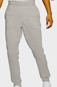 Nike Standard Fit Taper Leg is a pair of men's activewear jogger pants made of a cotton-polyester blend fabric. The pants have a drawstring closure and an elastic waistband for a comfortable fit. They are designed for running and jogging activities and come in gray color with a tapered leg style. The inseam length is 32 inches, and the waist size is L. The Nike brand is known for its quality and performance, making these pants a reliable choice for any sports enthusiast. Nike Sportswear Mens, Nike Brown, Tapered Joggers, Nike Sweats, Trouser Outfits, Nike Fleece, Mens Club, Nike Training, Fleece Sweatpants