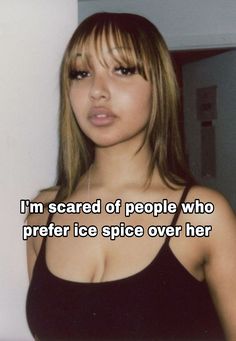 a woman in black top with text on it that reads, i'm scared of people who prefer ice spice over her