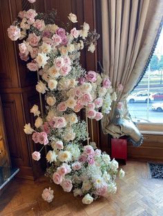 a tall vase filled with lots of pink and white flowers