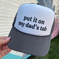 Get your hands on the On My Dad's Tab Trucker hat, the perfect accessory for any occasion. With its bold and witty slogan, "Put it on my dad's tab," this hat is sure to make a statement. Show off your sense of humor and relaxed style while also enjoying the practical benefits of sun protection. A must-have for any hat collection. Snap back Trucker Otto Snackback color: black Ships in 10 business days or sooner Funny Snapback Hat With Letter Print, Funny Trucker Hat With Letter Print, Funny Letter Print Trucker Hat, Funny Hats With Letter Print As Gift, Funny Hats With Letter Print, Funny Letter Print Hats For Gift, Funny Letter Print Hats As Gifts, Funny Letter Print Hat As Gift, Father's Day Hats With Letter Print