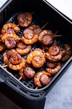 shrimp skewers in an air fryer with toothpicks on the side