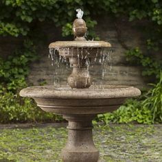 a bird is sitting on top of a fountain