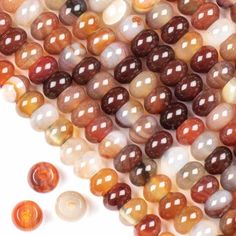 multicolored agate beads with white, brown and black dots on the side