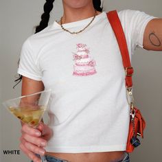 🎂 Sweeten your style with this Y2K inspired coquette baby tee! Perfect for cake lovers, this pink graphic t-shirt is a summer must-have. Embrace your feminine side with this trendy cake design. Whether you're out with friends or just lounging at home, this tee will keep you comfortable and stylish all season long! ☀️🌸  Looking for a graphic baby tee nostalgic of the 90s? Bring your Y2K outfit dreams to life with our newest collection. This classic baby tee will fit like a well-loved favorite f Fitted Sweet Top With Graphic Print, White Fitted Sweet Top, White Fitted Sweet Style Top, Sweet Fitted Cotton T-shirt, White Fitted T-shirt For Birthday, Fitted Short Sleeve Tops For Birthday, Fitted Cotton Tops For Birthday, Fitted Cotton T-shirt For Birthday, Fitted White Top For Birthday