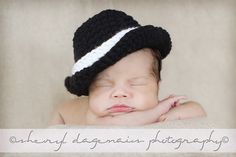 a newborn baby wearing a black and white crochet hat with the words, already afghanna photography