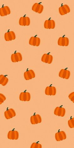 an orange background with small pumpkins on it