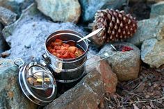 the camping side dish recipe is ready to be cooked in an outdoor pot and pan