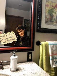 a woman is taking a selfie in the bathroom mirror